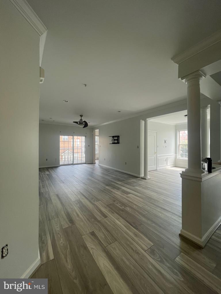 9713 Handerson Place, Unit 304 Manassas Park, VA 20111 - Photo 3 of 14 wooden floor in an empty room with a window