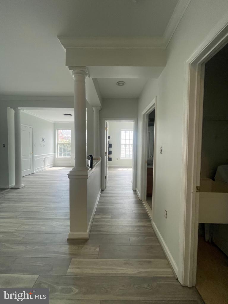 9713 Handerson Place, Unit 304 Manassas Park, VA 20111 - Photo 4 of 14 a view of a hallway with wooden floor