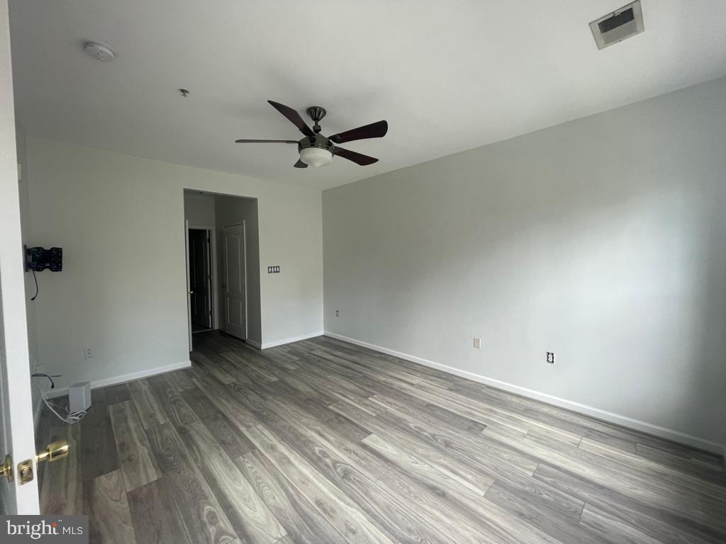 9713 Handerson Place, Unit 304 Manassas Park, VA 20111 - Photo 5 of 14 wooden floor in an empty room