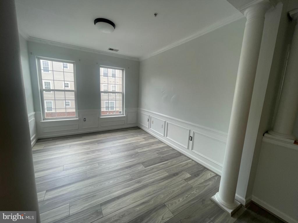 9713 Handerson Place, Unit 304 Manassas Park, VA 20111 - Photo 8 of 14 an empty room with wooden floor and windows