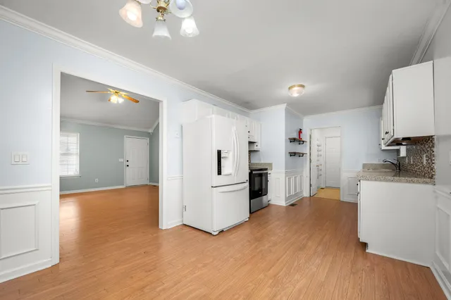 a view of an empty room with window and cabinet