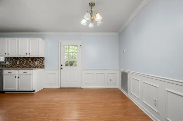 a kitchen with granite countertop stainless steel appliances and refrigerator