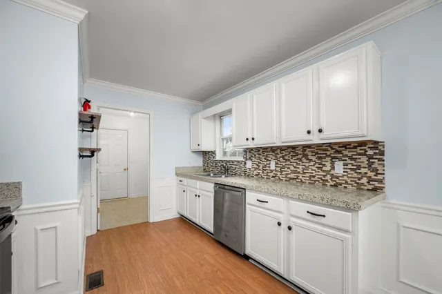 a kitchen with a sink a refrigerator and window