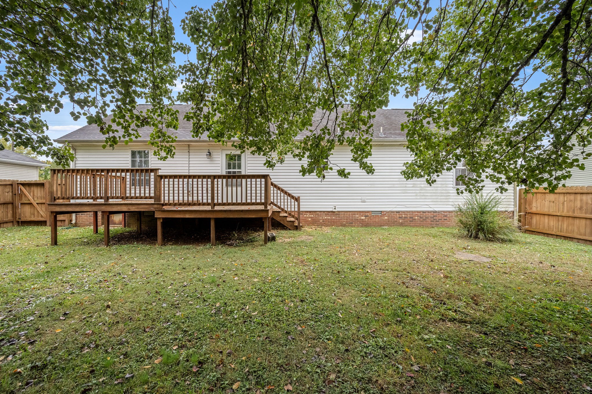 2403 Medford Campbell Boulevard Murfreesboro, TN 37127 - Photo 32 of 35 a view of backyard with large trees and wooden fence