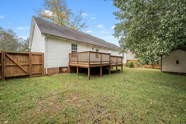 a backyard of a house with yard and trampoline