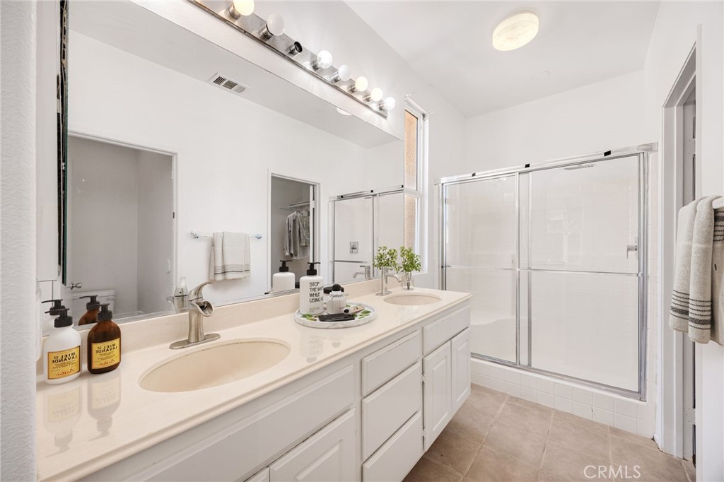 4546 Spring Court Banning, CA 92220 - Photo 12 of 17 a bathroom with a double vanity sink and mirror