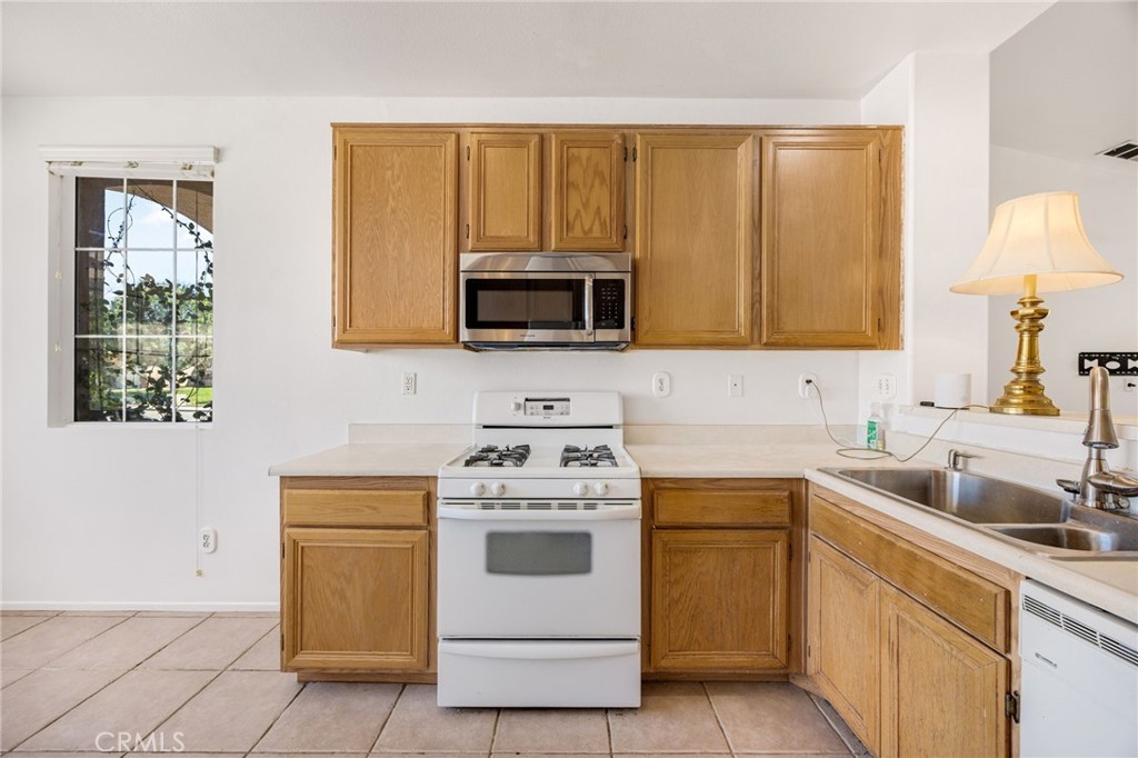 4546 Spring Court Banning, CA 92220 - Photo 6 of 17 a kitchen with a stove microwave and sink