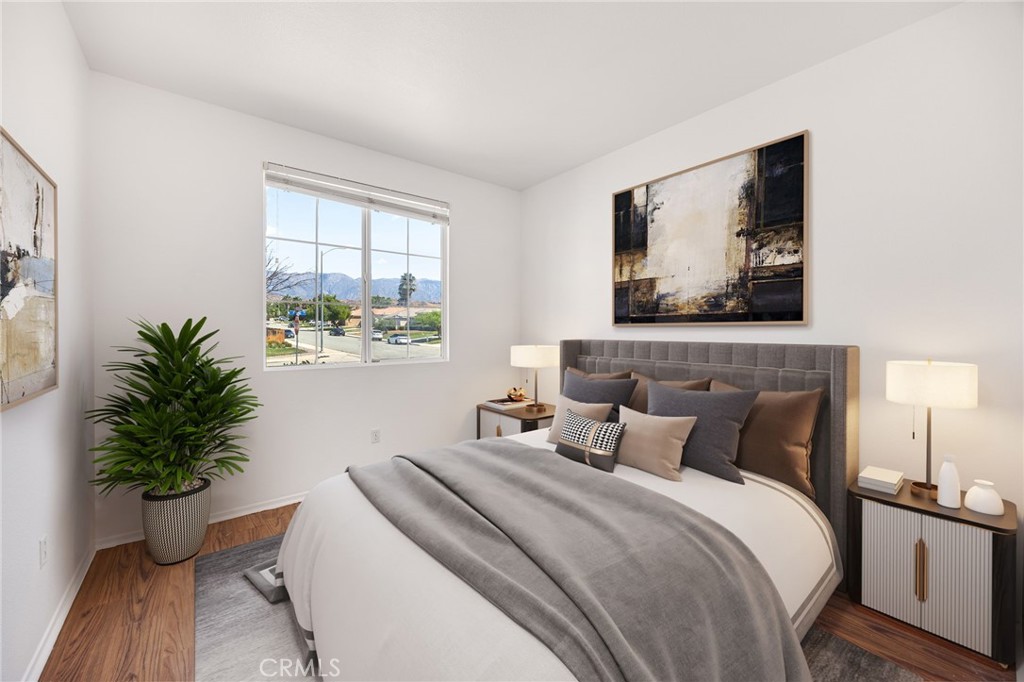 4546 Spring Court Banning, CA 92220 - Photo 8 of 17 a bedroom with a large bed and a potted plant