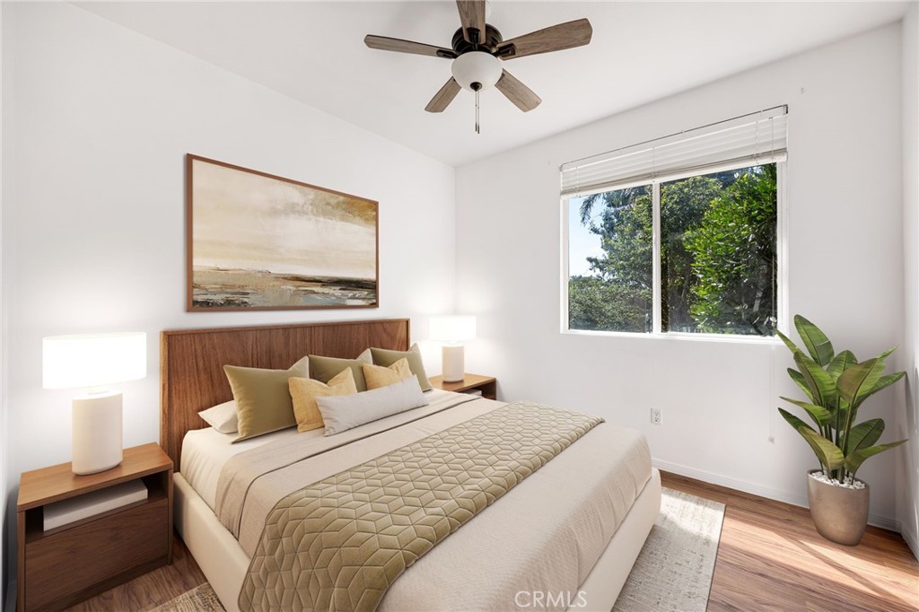 4546 Spring Court Banning, CA 92220 - Photo 10 of 17 a bedroom with a large bed and a potted plant