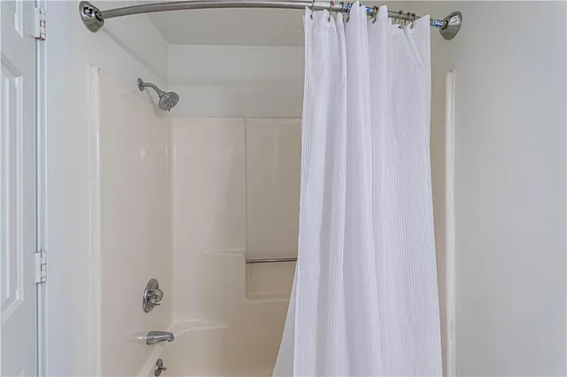a bathroom with a shower and a tub