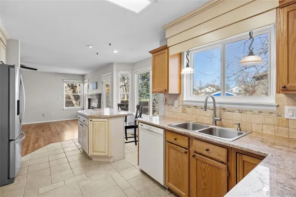 a kitchen with a refrigerator and a sink