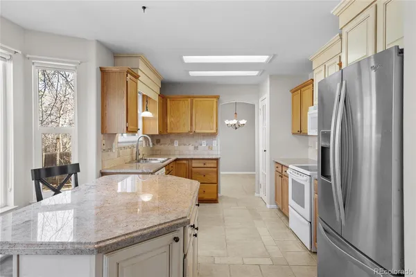a kitchen with granite countertop a sink and cabinets
