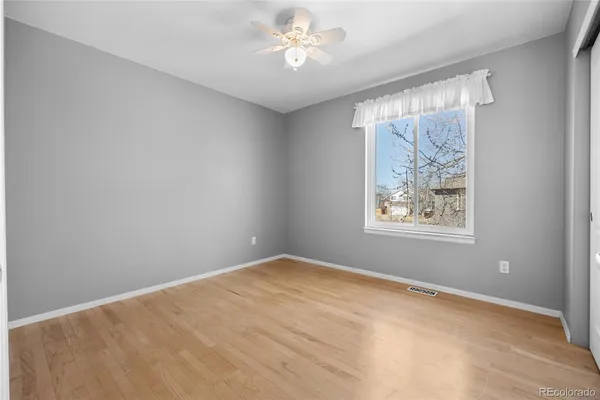 a view of an empty room with wooden floor