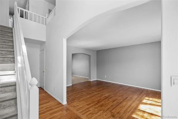 a view of a hallway with windows and entryway