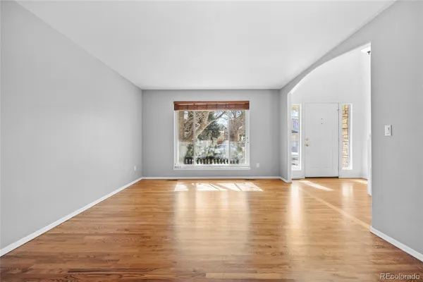 a view of an empty room and wooden floor