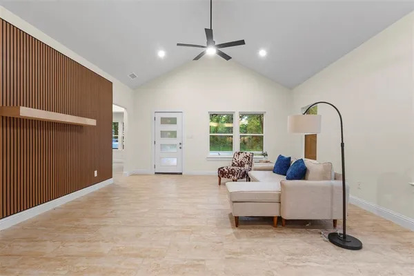 a living room with furniture and a large window
