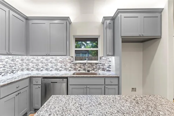 a kitchen with stainless steel appliances kitchen island granite countertop a sink stove and granite counter top