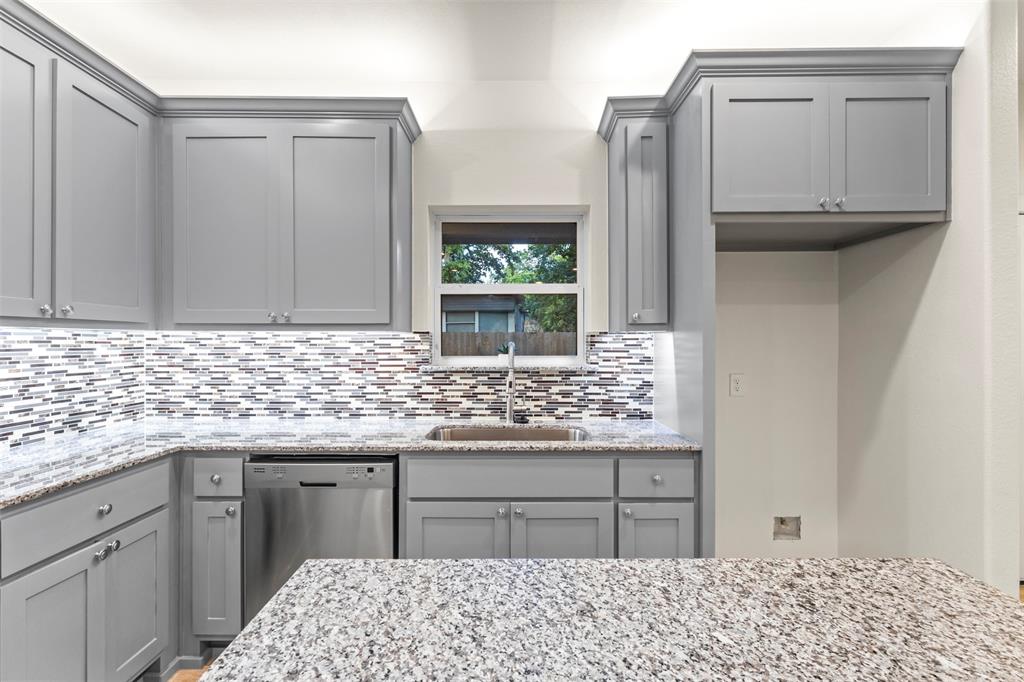 117 Pawnee Trail Mabank, TX 75156 - Photo 23 of 40 a kitchen with stainless steel appliances kitchen island granite countertop a sink stove and granite counter top