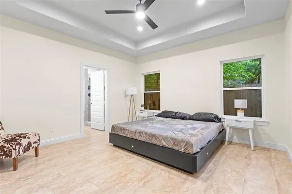 a large kitchen with kitchen island granite countertop a stove top oven a sink a dining table and chairs