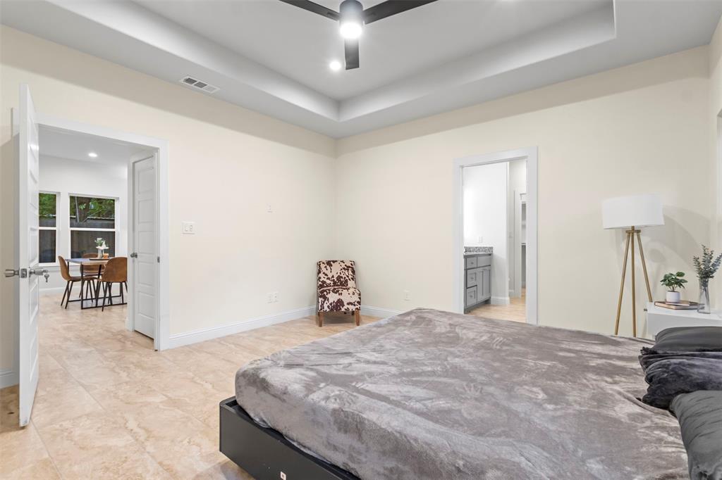 117 Pawnee Trail Mabank, TX 75156 - Photo 26 of 40 a bedroom with a bed and a chandelier