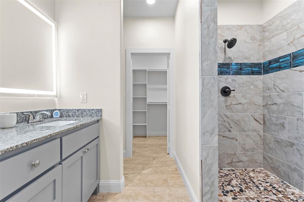 117 Pawnee Trail Mabank, TX 75156 - Photo 27 of 40 a bathroom with a granite countertop sink a shower and a mirror