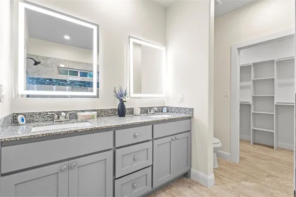 a bathroom with a granite countertop sink a shower and a mirror