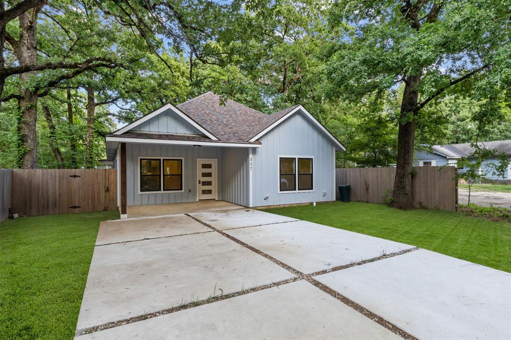 117 Pawnee Trail Mabank, TX 75156 - Photo 3 of 40 a front view of a house with a yard and trees