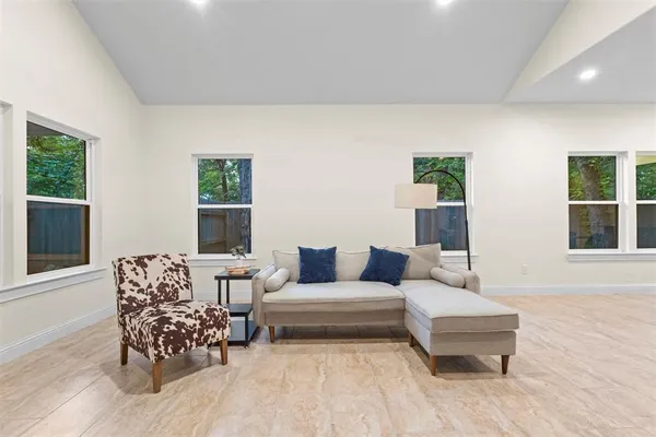 a living room with furniture and kitchen view