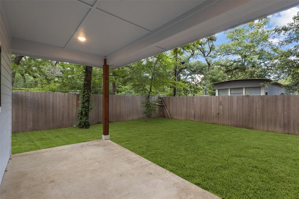 117 Pawnee Trail Mabank, TX 75156 - Photo 8 of 40 a view of a backyard with a small cabin