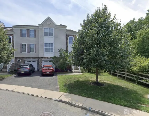a view of a cars parked in front of a brick house