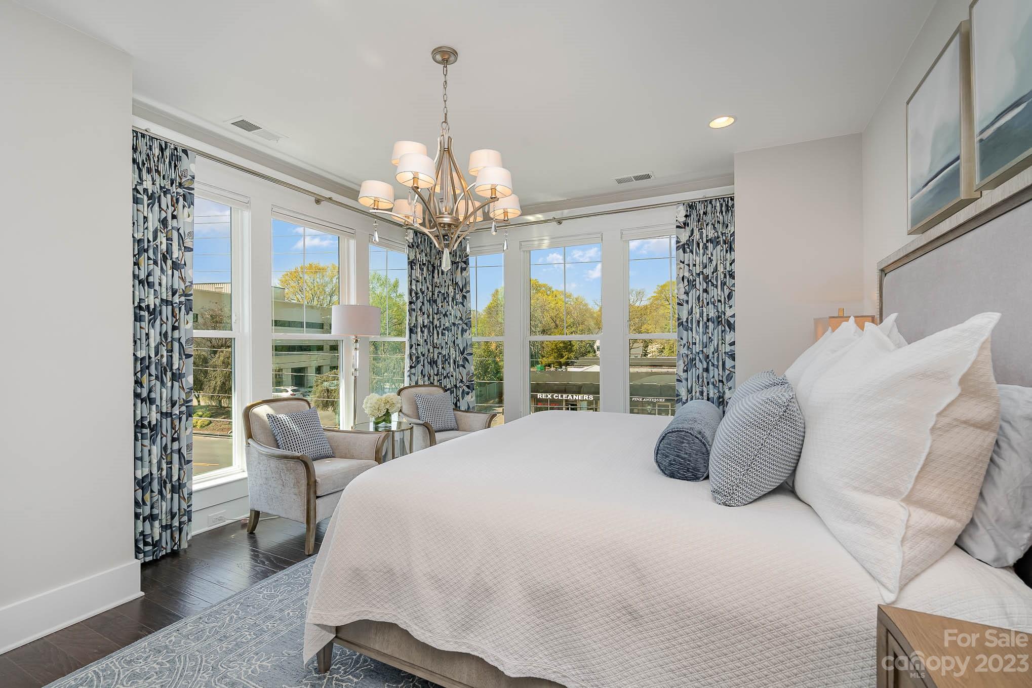 1103 Reece Road Charlotte, NC 28209 - Photo 12 of 32 a spacious bedroom with a bed and a chandelier