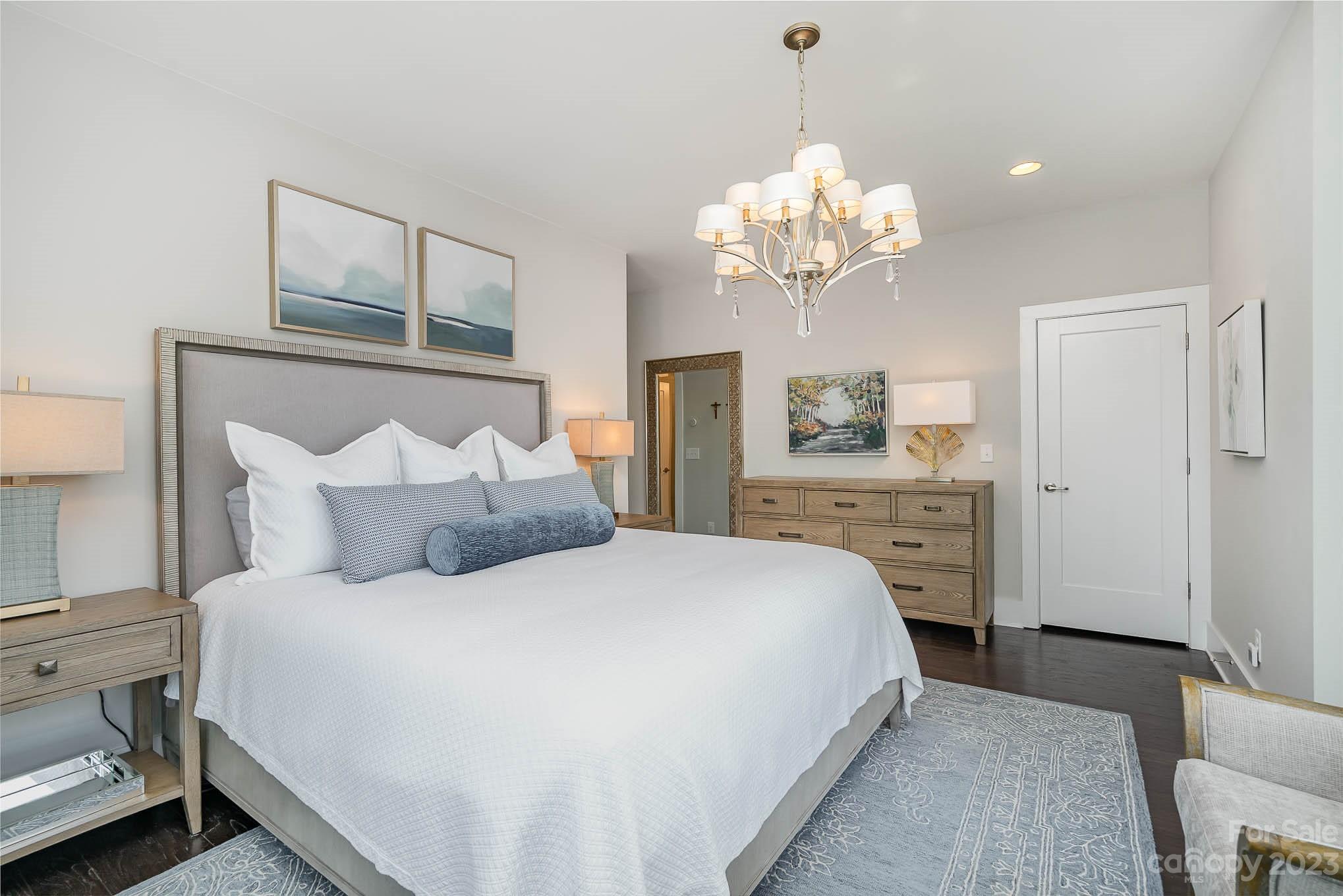 1103 Reece Road Charlotte, NC 28209 - Photo 13 of 32 a spacious bedroom with a bed and a chandelier