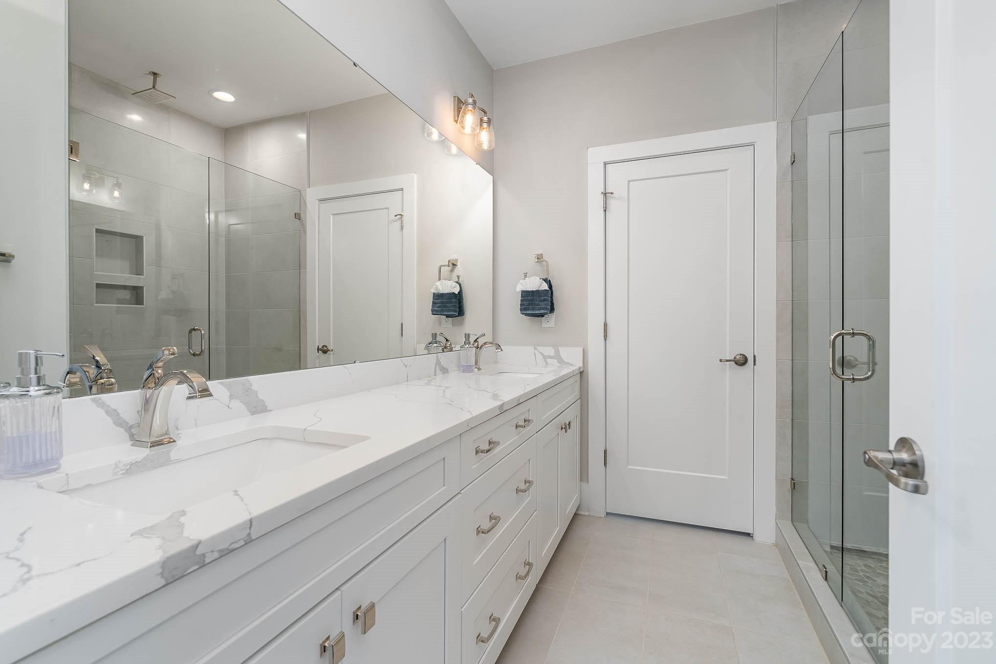 1103 Reece Road Charlotte, NC 28209 - Photo 17 of 32 a bathroom with a double vanity sink mirror and shower