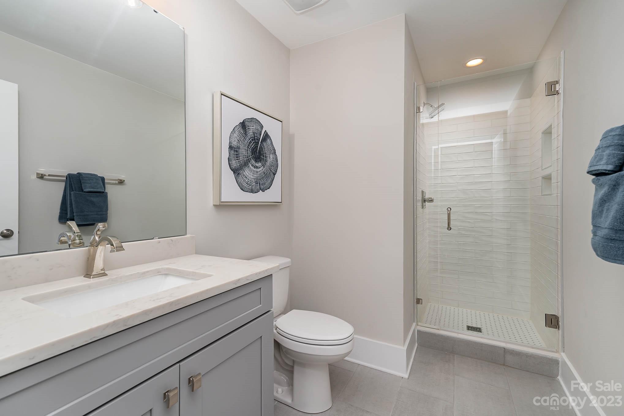 1103 Reece Road Charlotte, NC 28209 - Photo 18 of 32 a bathroom with a sink a toilet and shower