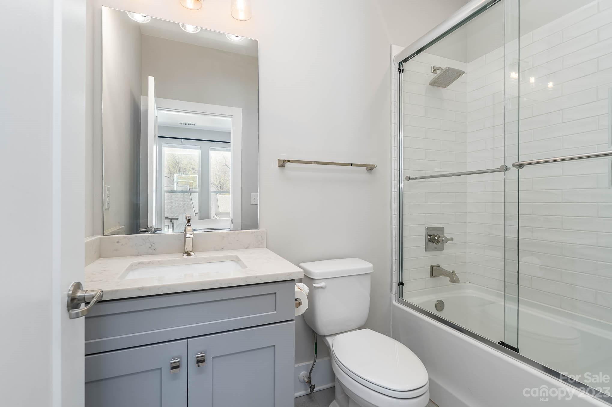 1103 Reece Road Charlotte, NC 28209 - Photo 19 of 32 a bathroom with a sink toilet vanity and shower