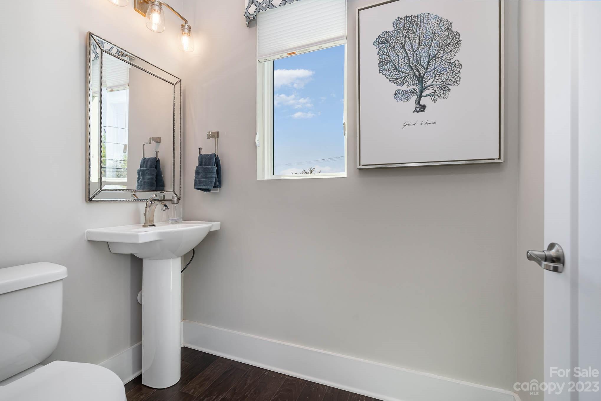 1103 Reece Road Charlotte, NC 28209 - Photo 20 of 32 a bathroom with a toilet a sink and mirror