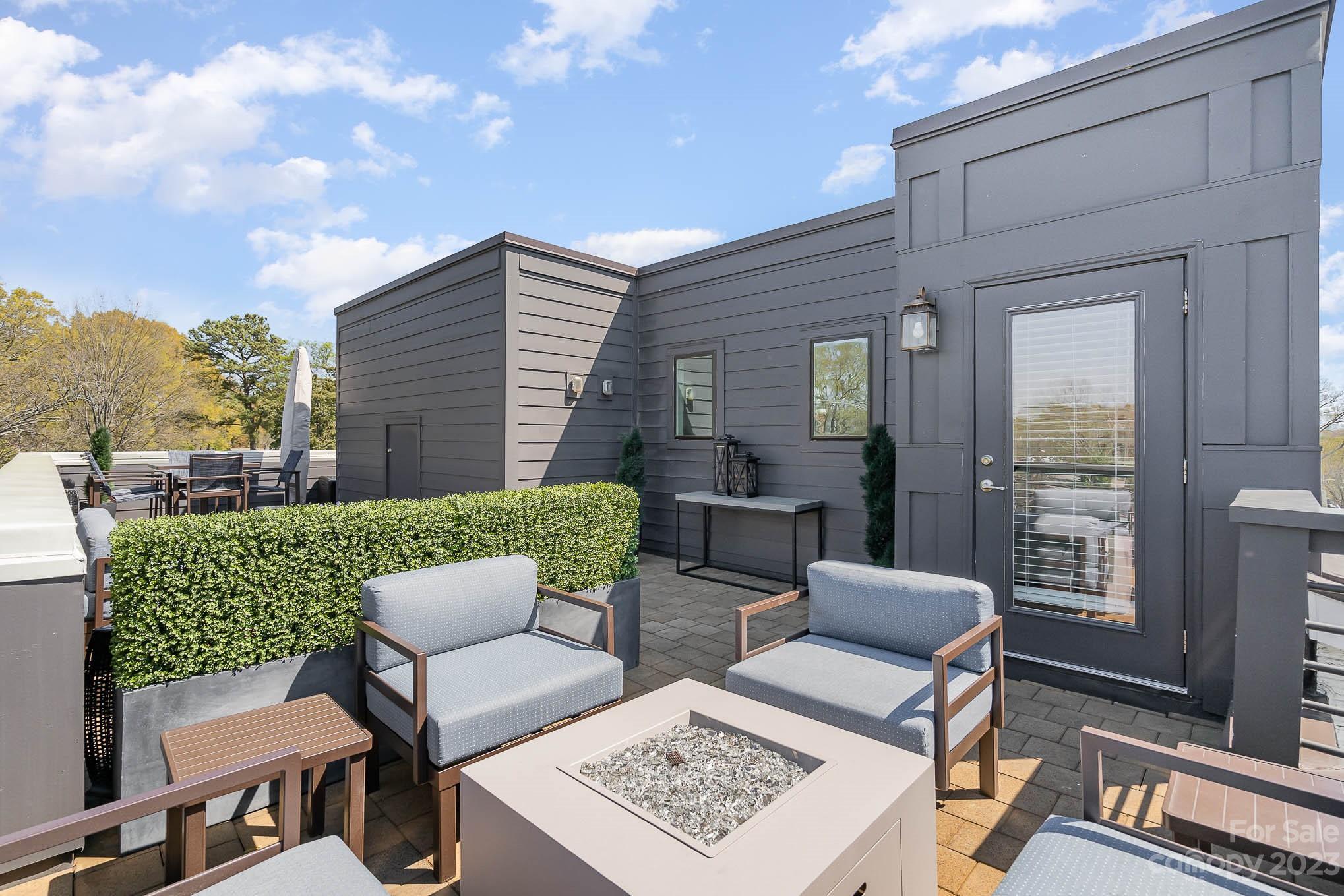 1103 Reece Road Charlotte, NC 28209 - Photo 24 of 32 a view of a patio with couches table and chairs and potted plants
