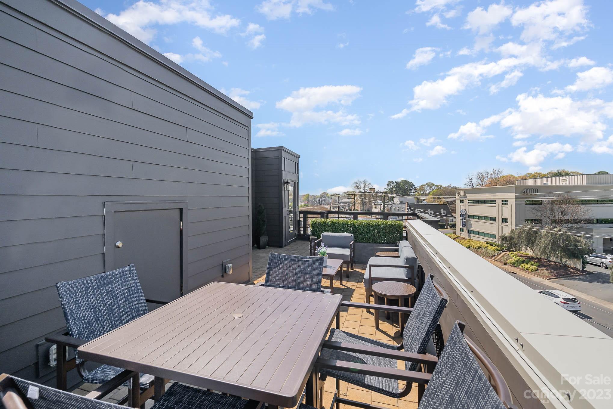 1103 Reece Road Charlotte, NC 28209 - Photo 25 of 32 a view of a roof deck with table and chairs