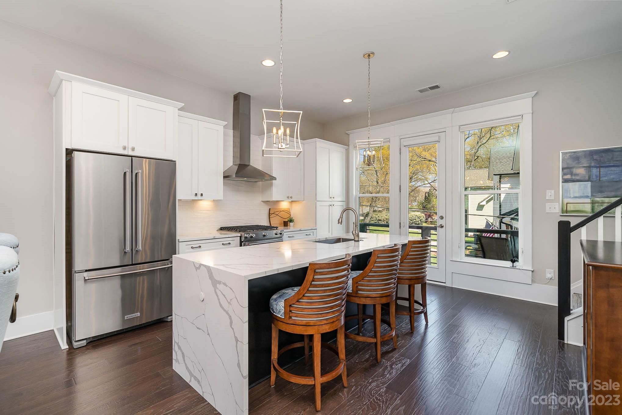 1103 Reece Road Charlotte, NC 28209 - Photo 6 of 32 a kitchen with stainless steel appliances granite countertop a refrigerator a sink dishwasher a stove and a refrigerator with wooden floor