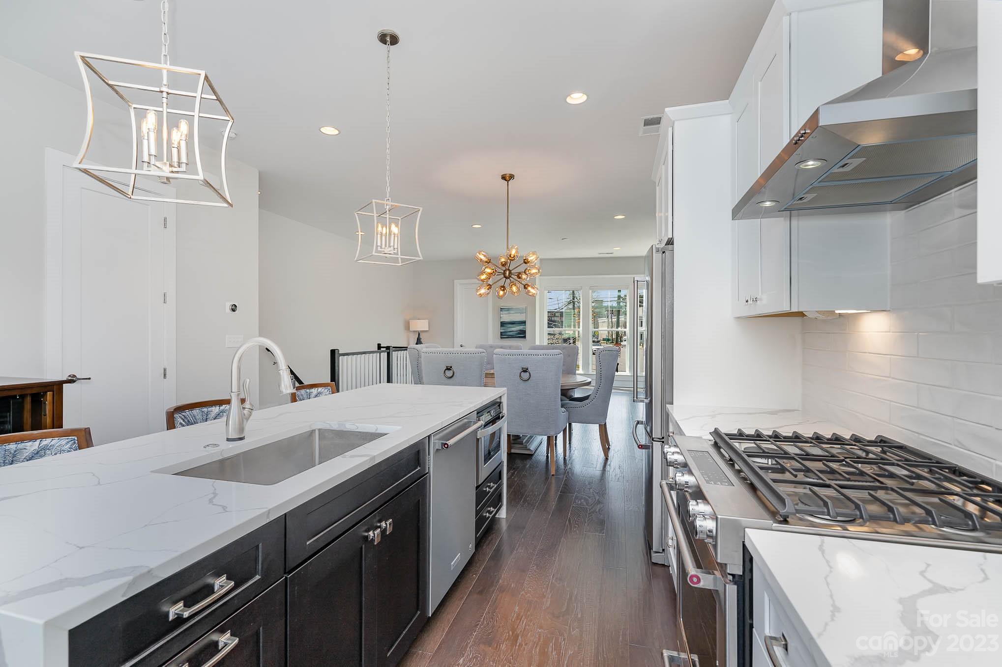 1103 Reece Road Charlotte, NC 28209 - Photo 7 of 32 a kitchen with sink stove and cabinets