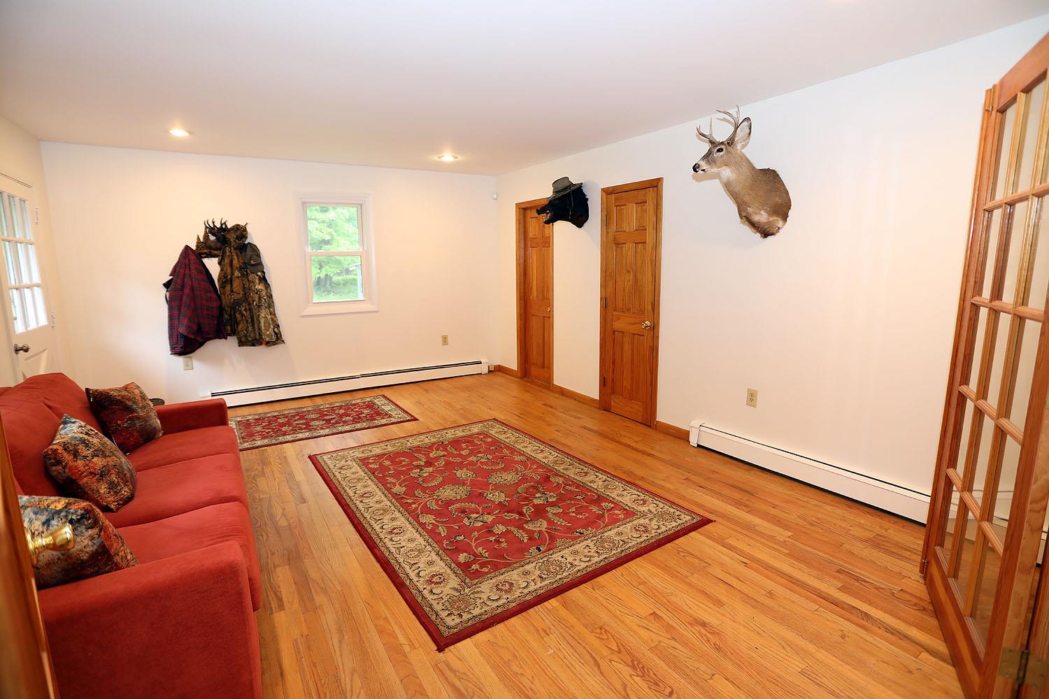 342 Bernas Road Cochecton, NY 12726 - Photo 16 of 48 a living room with a rug and a table