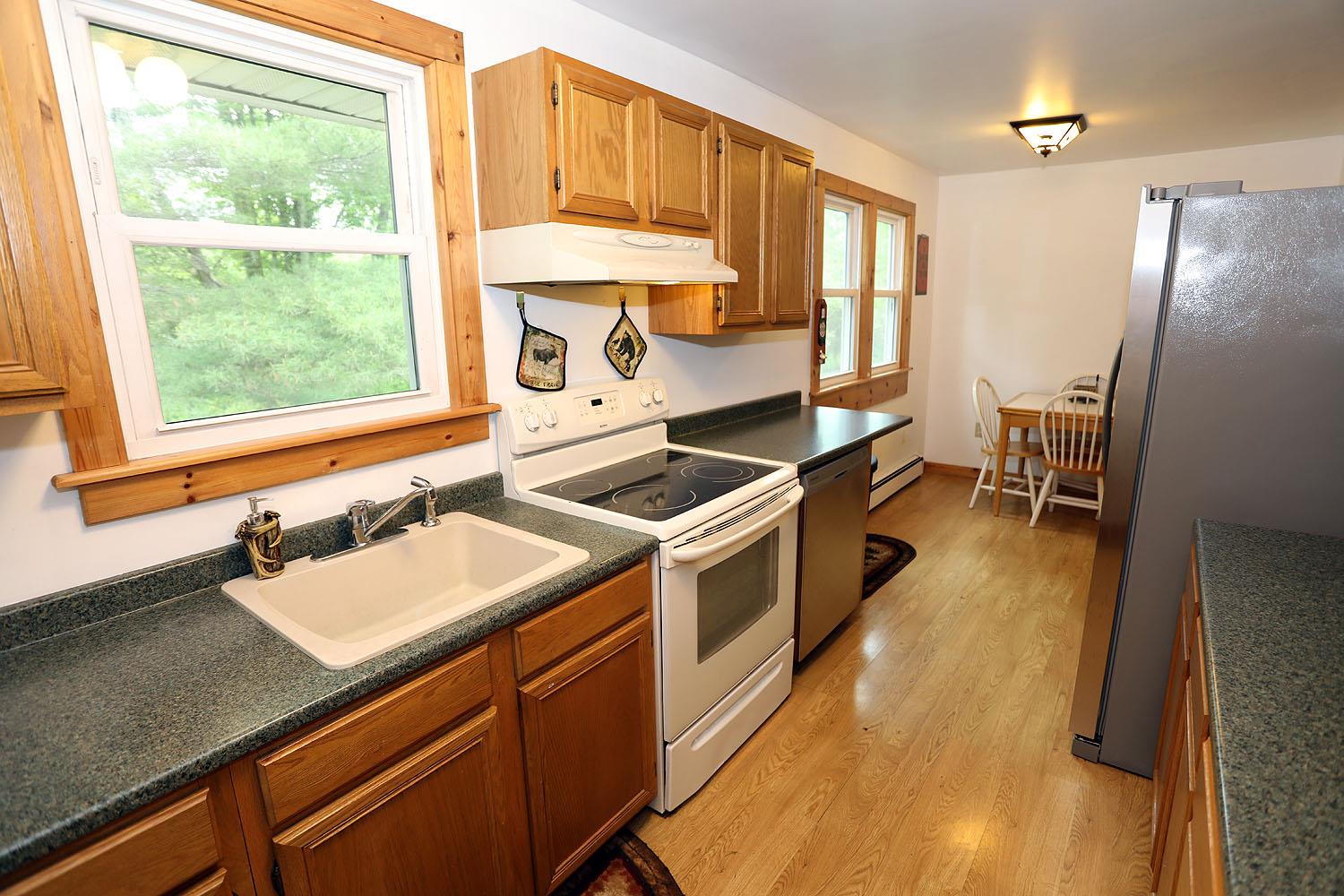 342 Bernas Road Cochecton, NY 12726 - Photo 23 of 48 a kitchen with a sink stove and refrigerator