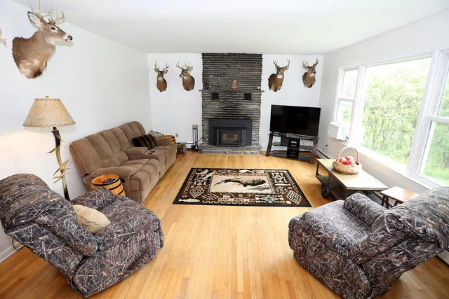 a living room with furniture rug and a table