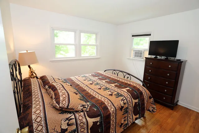 a bed sitting in a bedroom next to a window