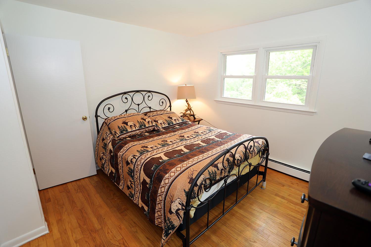 342 Bernas Road Cochecton, NY 12726 - Photo 34 of 48 a bed sitting in a bedroom next to a window