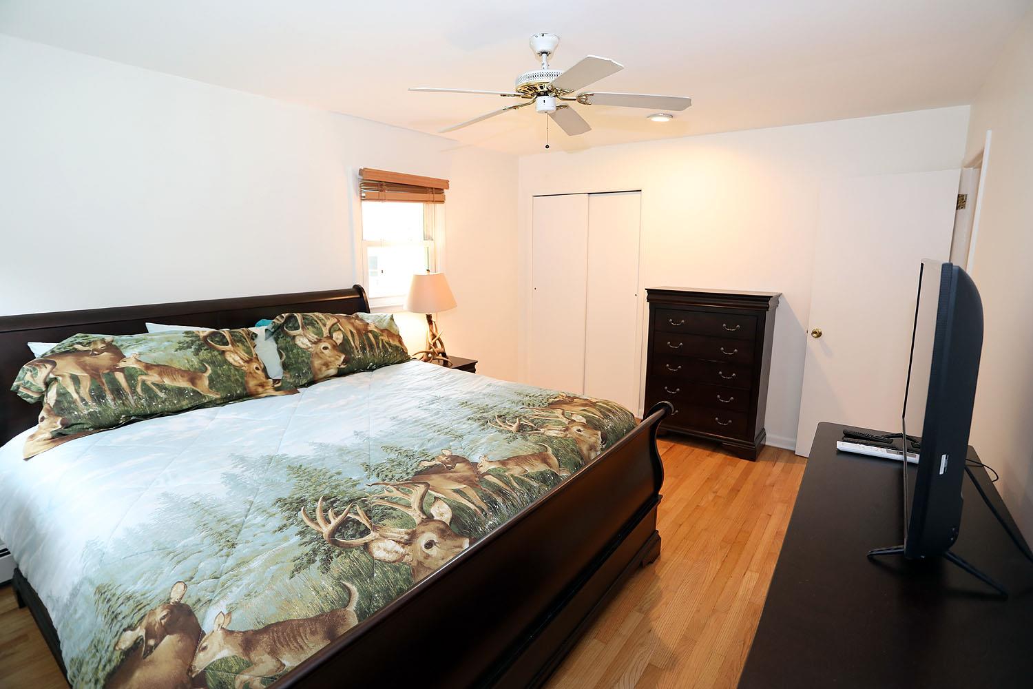 342 Bernas Road Cochecton, NY 12726 - Photo 36 of 48 a bedroom with a bed and wooden floor