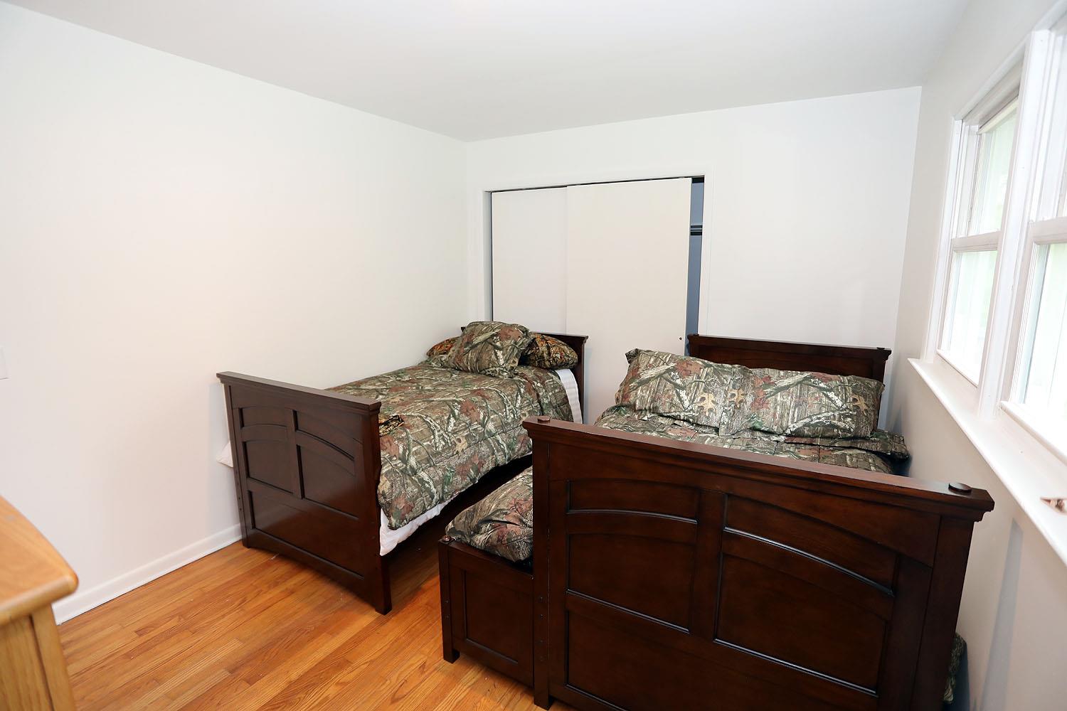 342 Bernas Road Cochecton, NY 12726 - Photo 39 of 48 a bed sitting in a bedroom next to a window with dresser