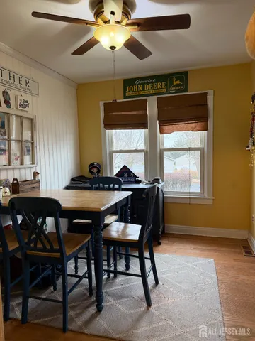 a view of a dining room with furniture and a chandelier