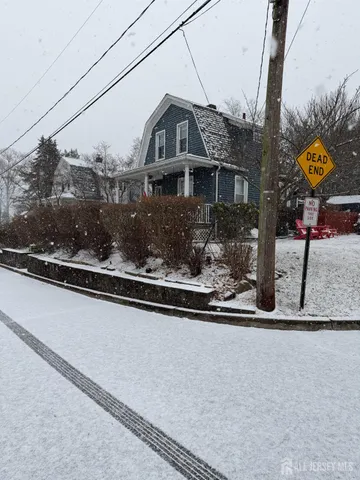 a view of a house with a yard and sitting area