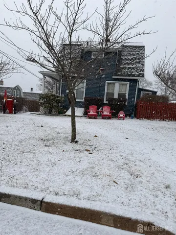 a view of a house with a snow in the yard